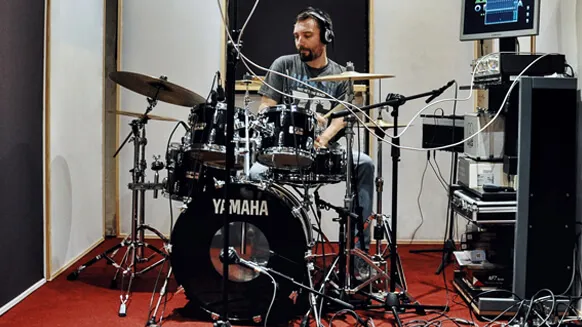A drummer recording in the studio