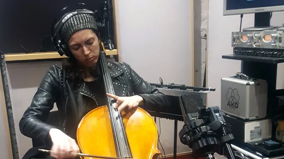 A cellist recording in the studio