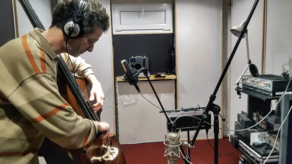 A double bass player recording