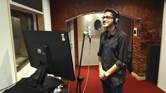 A singer recording vocals under the brick arch