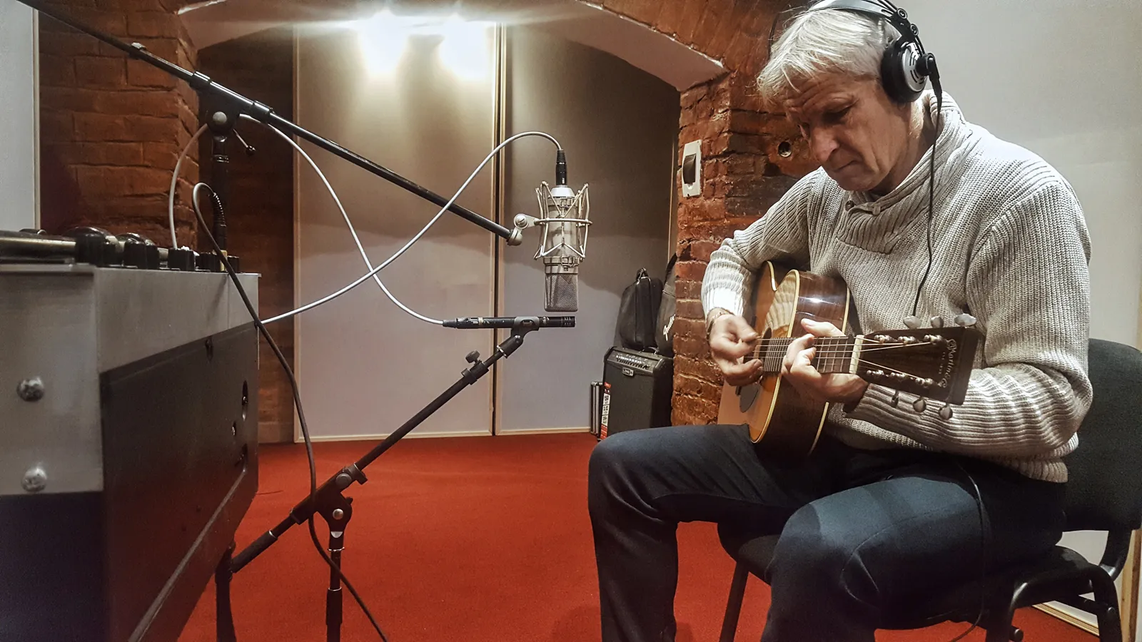 A guitarist recording acoustic guitar