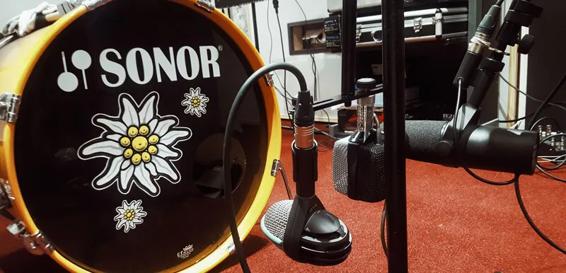 Drum kit and microphones in the recording room